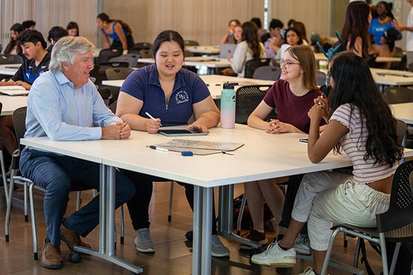 John Hutchinson talking with students