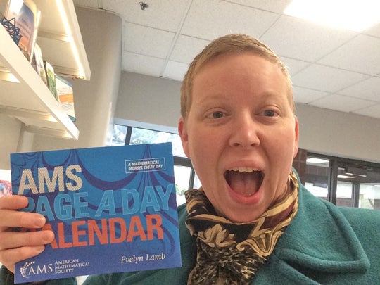 Evelyn Lamb '12 holding an AMS calendar she wrote